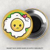 Super cute yellow 1.75" round button magnet with a over easy egg on it in a cartoon style